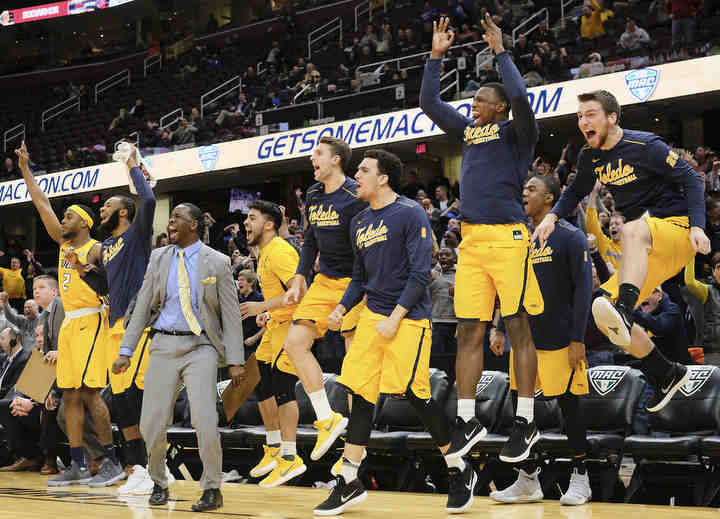 University of Toledo players celebrate defeating Eastern Michigan 64-63 in a MAC Tournament semifinal basketball game at Quicken Loans Arena in Cleveland.    (Jeremy Wadsworth / The Blade)